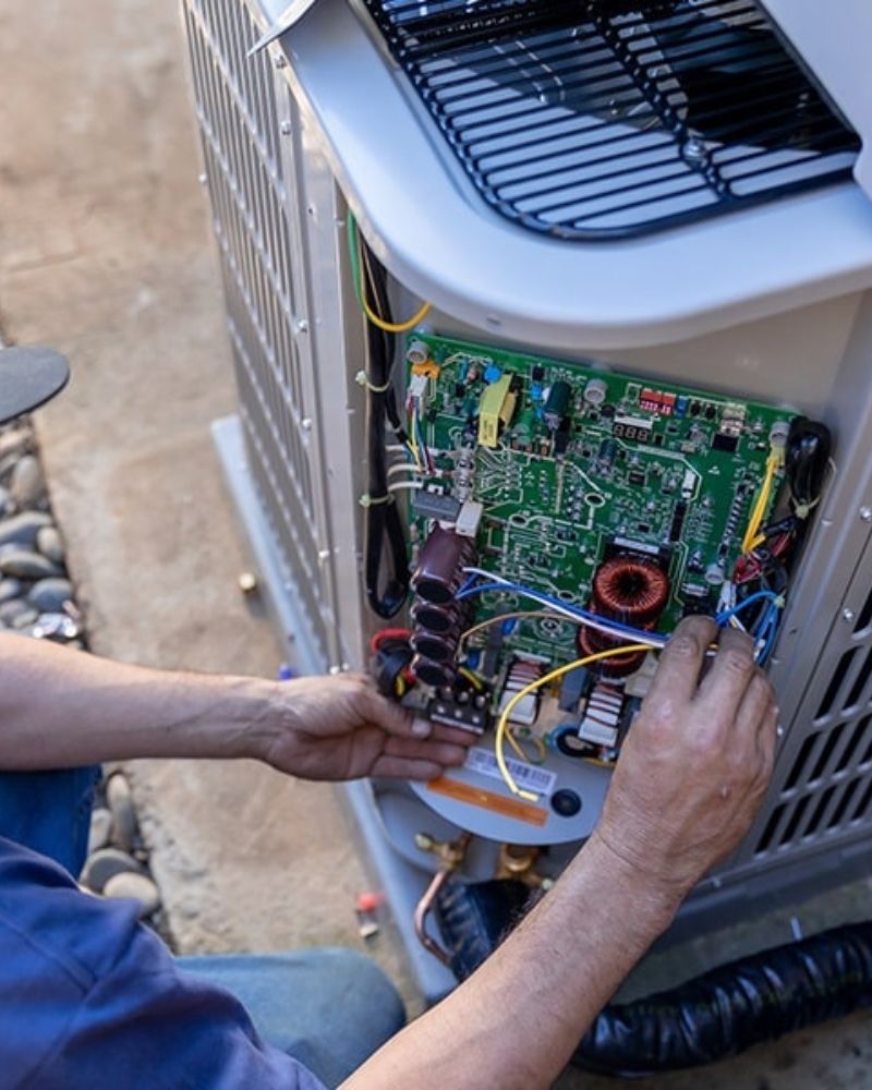 HVAC technician working on air conditioning equipment